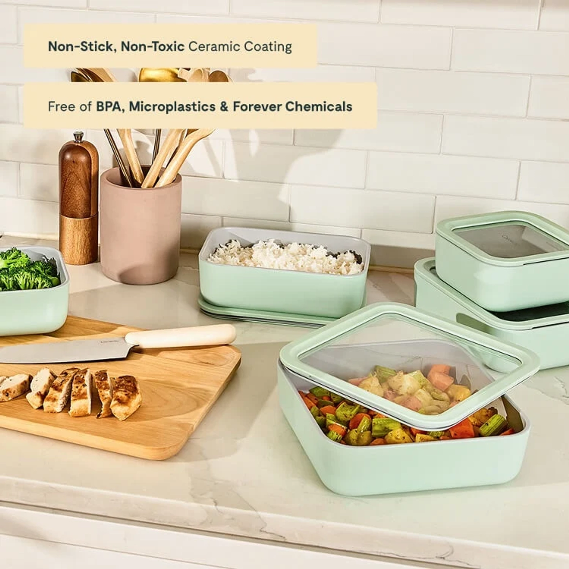 Caraway sage green food storage containers on a kitchen counter, filled with rice, roasted vegetables, and broccoli beside a cutting board with sliced chicken, with text overlays reading "Non-Stick, Non-Toxic Ceramic Coating" and "Free of BPA, Microplastics & Forever Chemicals."