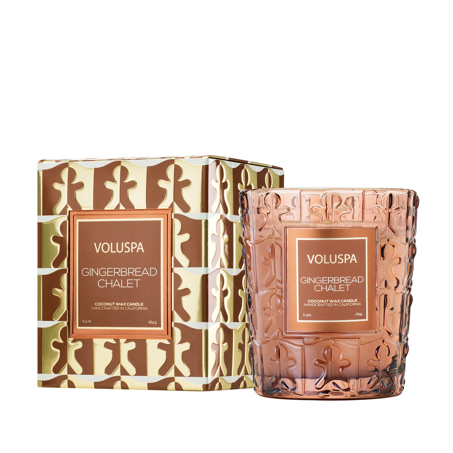 Voluspa Gingerbread Chalet candle in an embossed rose-brown glass jar with a gingerbread man pattern, shown beside its matching brown and metallic gold gift box on a white background.